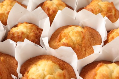 Photo of Tasty muffins as background, closeup. Fresh pastry