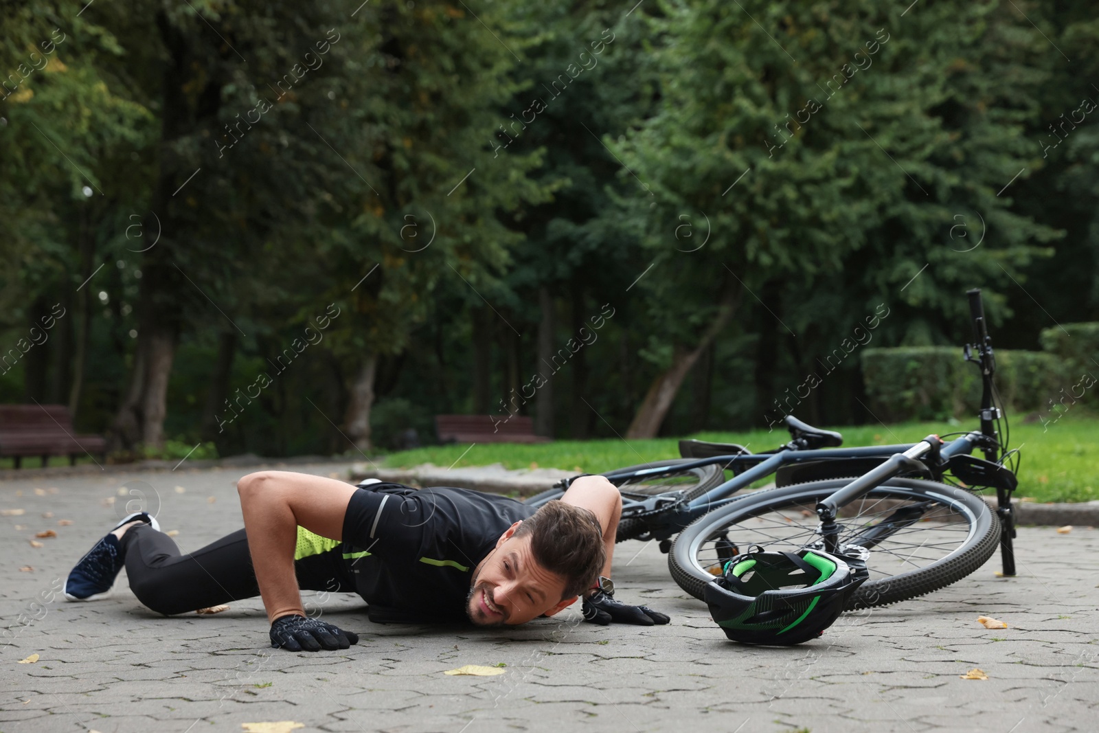 Photo of Man fallen off his bicycle in park