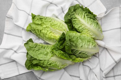 Photo of Fresh green romaine lettuces on grey table, flat lay