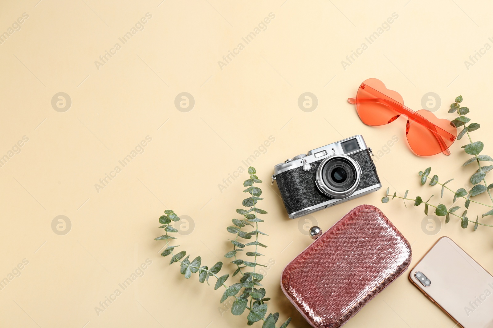 Photo of Flat lay composition with professional photographer camera, smartphone and accessories on beige background. Space for text