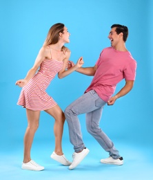 Photo of Beautiful young couple dancing on blue background