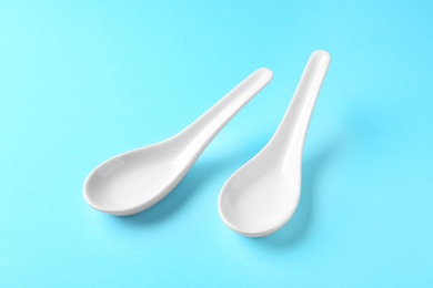 Clean Miso soup spoons on blue background