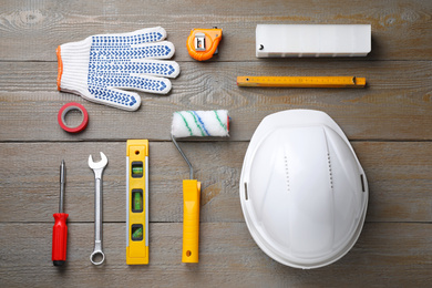 Flat lay composition with different construction tools on wooden background