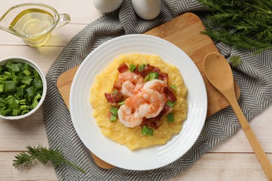 Photo of Plate with fresh tasty shrimps, bacon, grits and green onion on light wooden table, flat lay