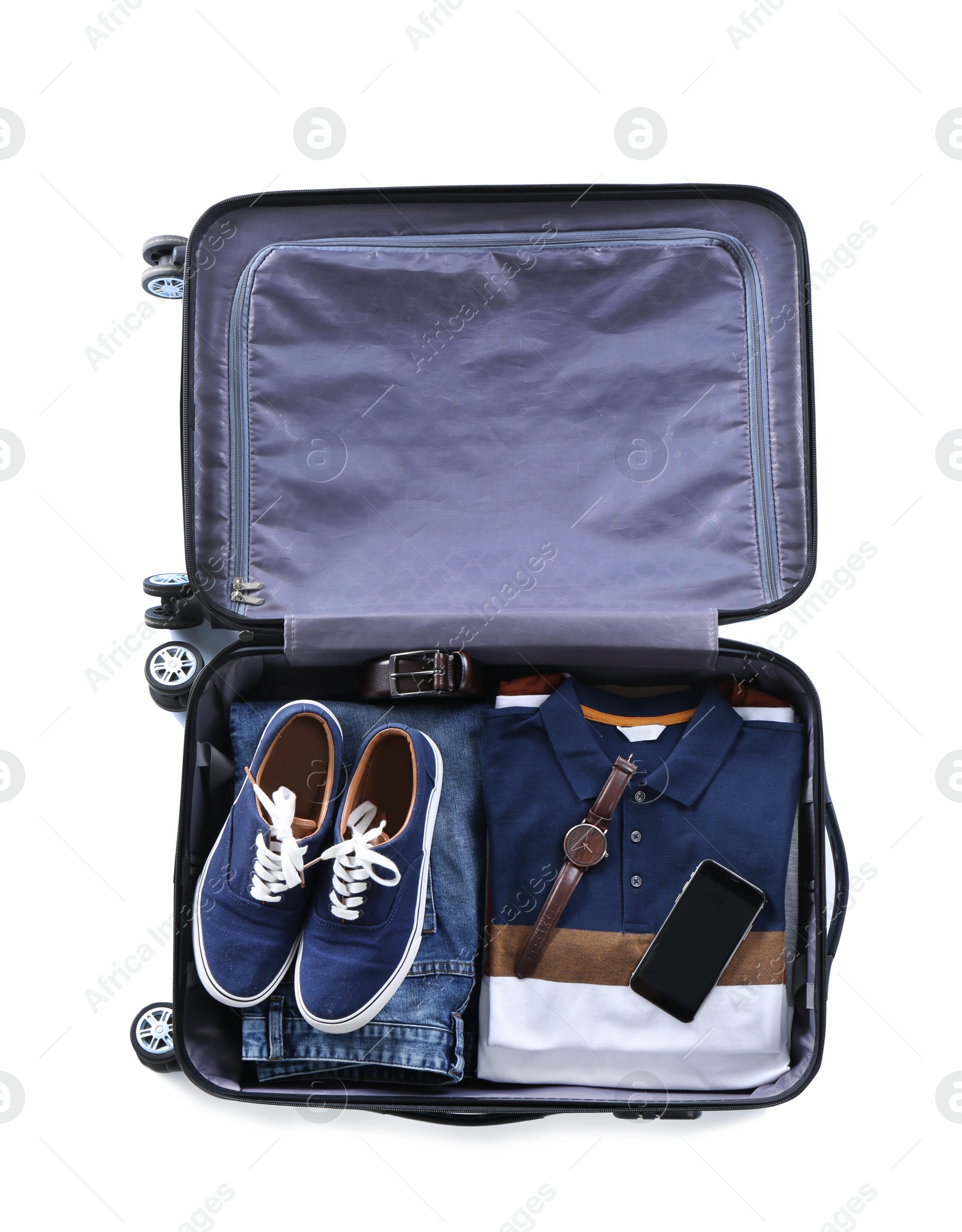 Photo of Open suitcase packed for travelling on white background, top view