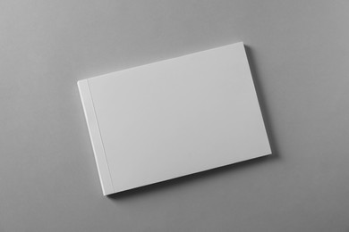 Photo of Brochure with blank cover on light grey background, top view