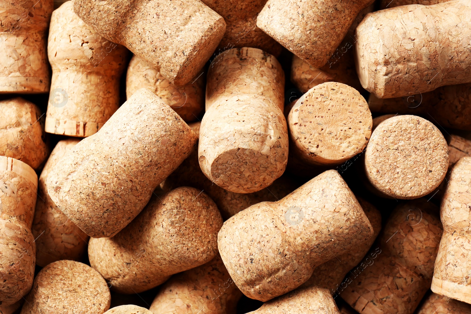 Photo of Many corks of wine bottles as background, top view