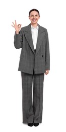 Photo of Beautiful businesswoman in suit showing gesture OK on white background