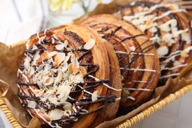 Photo of Delicious rolls with toppings and almond on table, closeup. Sweet buns