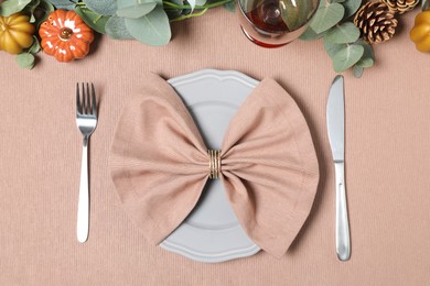 Photo of Autumn table setting with eucalyptus branches and pumpkins, flat lay