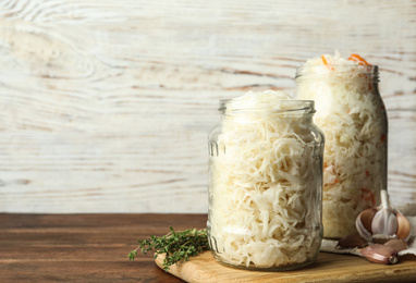 Tasty homemade fermented cabbage on wooden table