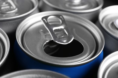 Photo of Energy drinks in cans as background, closeup. Functional beverage