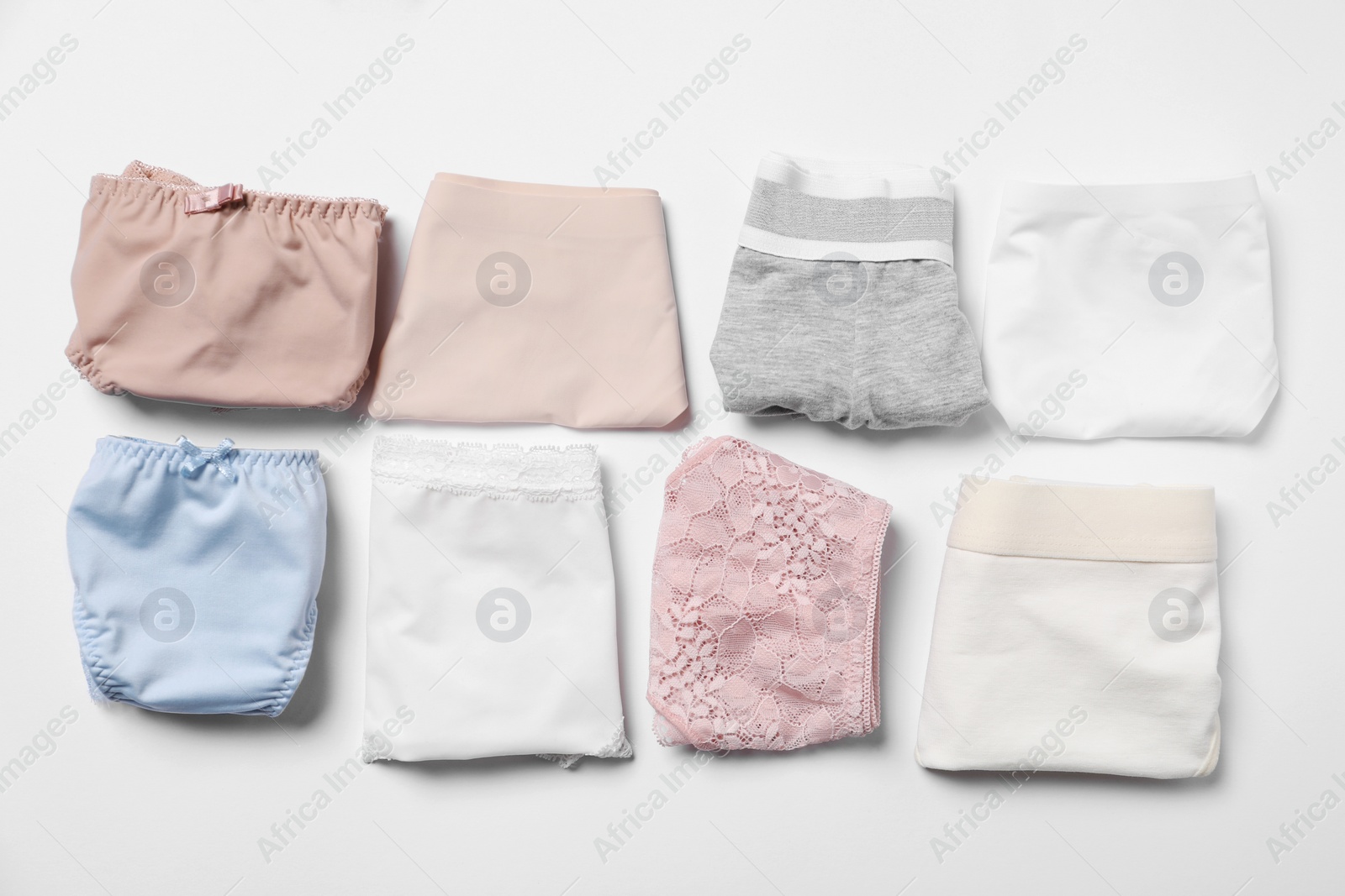 Photo of Stylish folded women's underwear on white background, flat lay