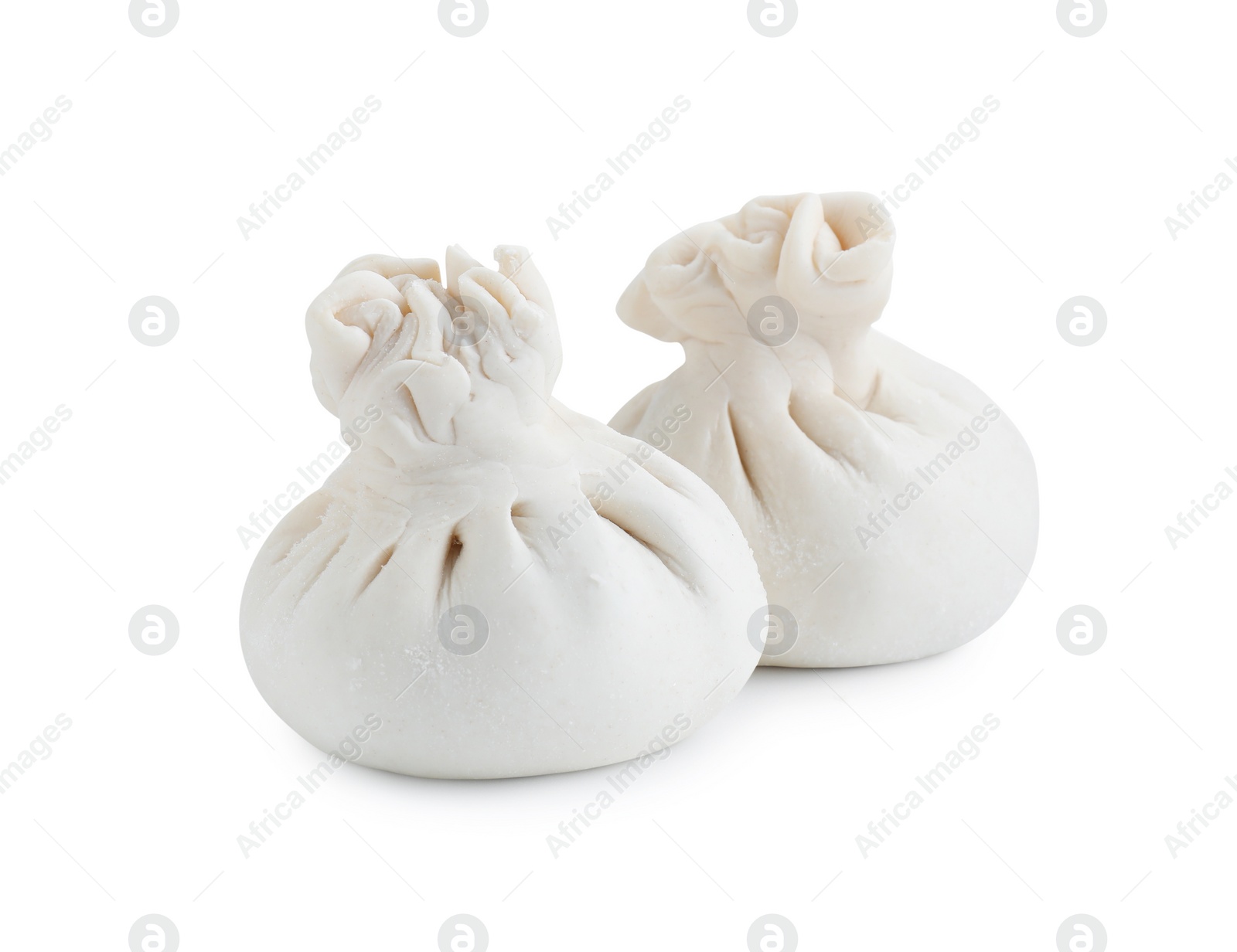 Photo of Uncooked khinkali (dumplings) isolated on white. Georgian cuisine