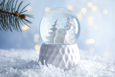 Photo of Glass globe with deer and trees on artificial snow