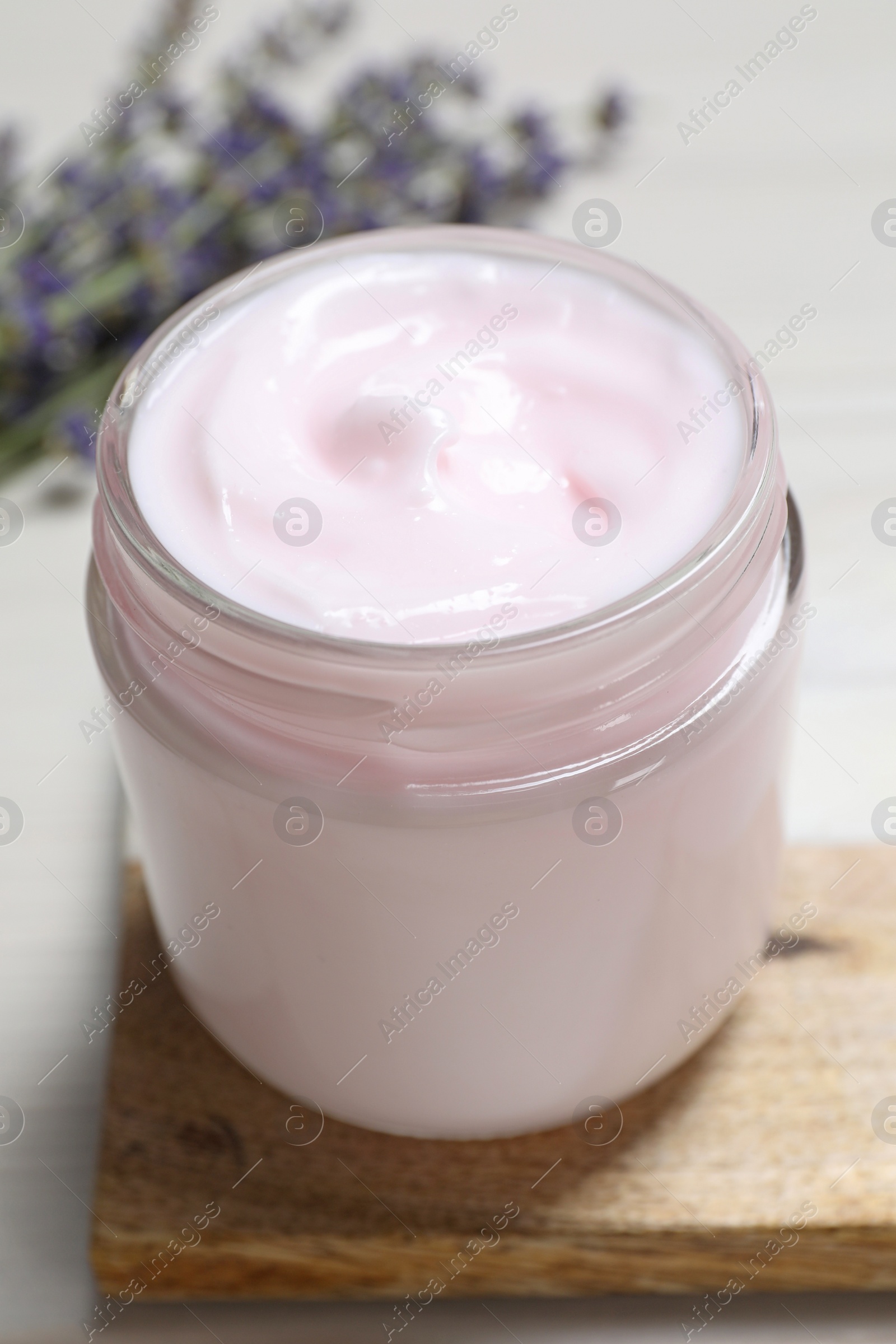 Photo of Jar of hand cream on white wooden table, closeup