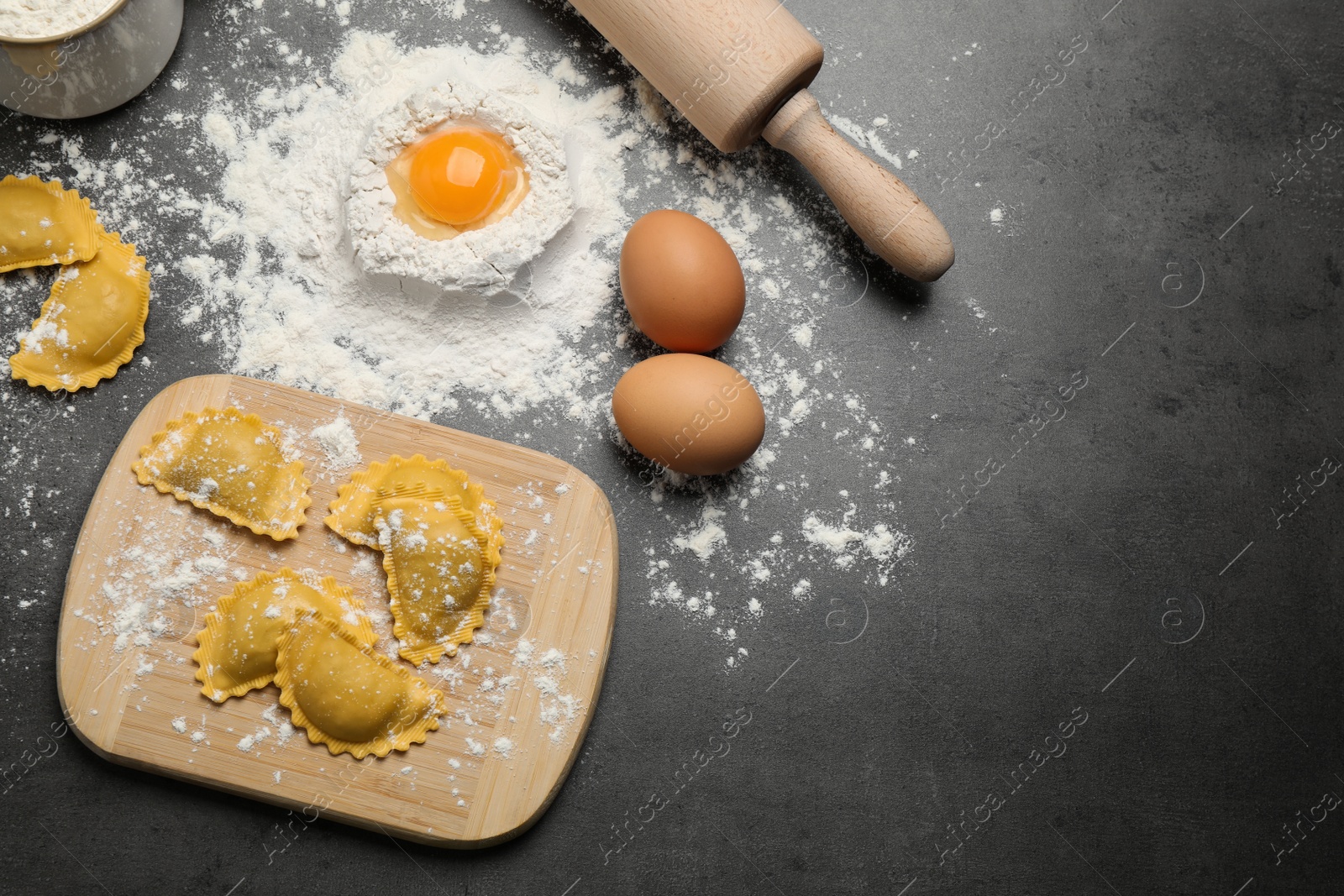 Photo of Flat lay composition with raw ravioli on grey table. Italian pasta