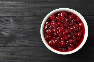 Photo of Fresh cranberry sauce on grey wooden table, top view. Space for text