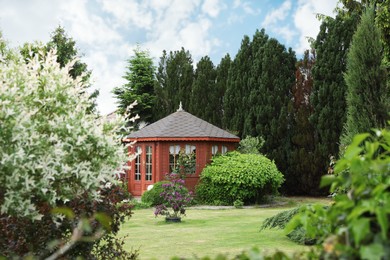 Picturesque view of gazebo in beautiful garden on sunny day