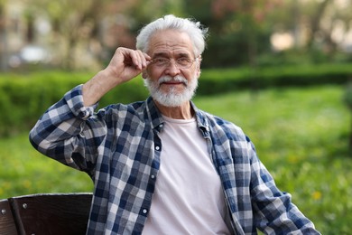 Photo of Portrait of happy grandpa with glasses outdoors