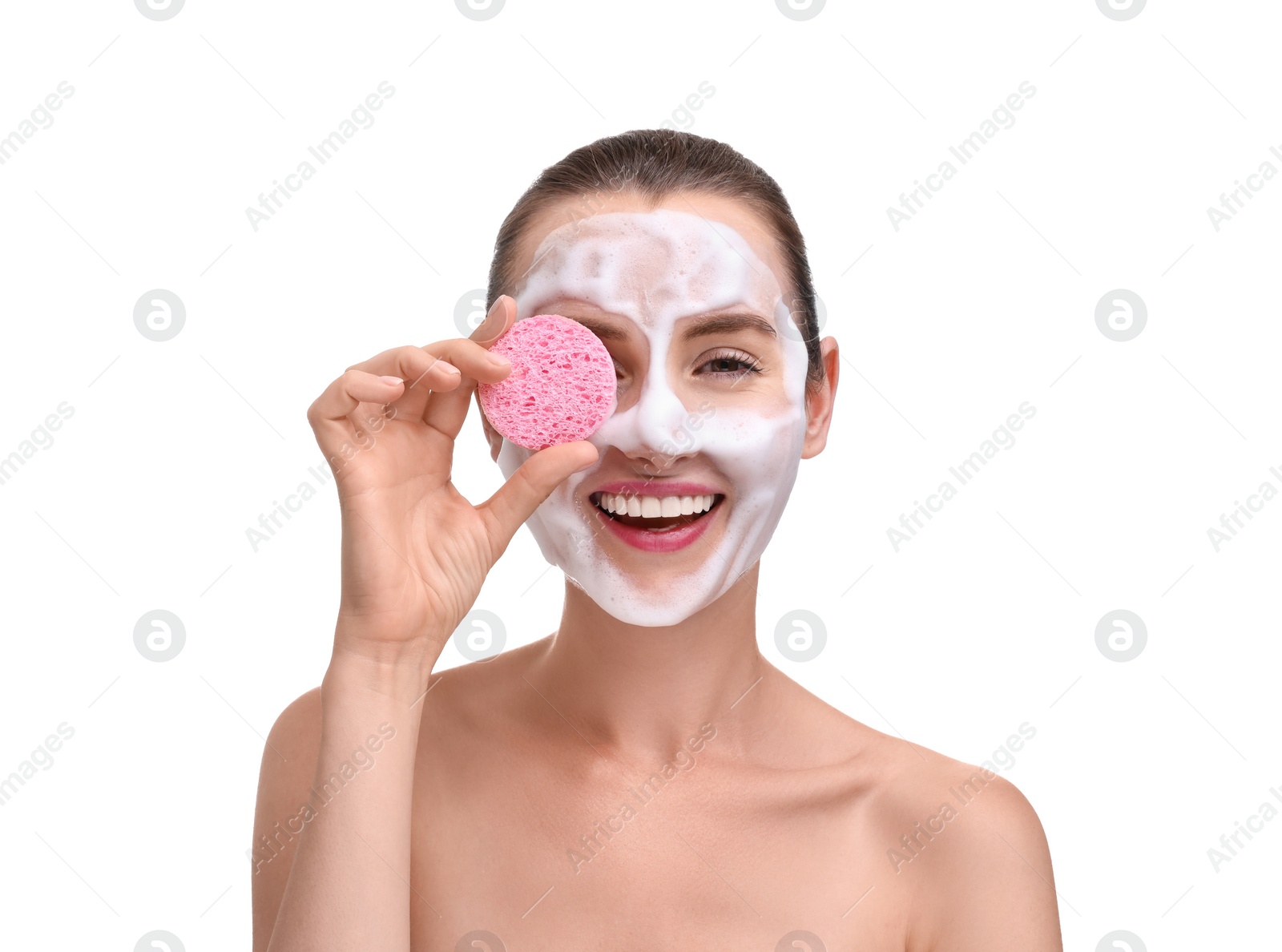 Photo of Happy young woman washing her face with sponge on white background