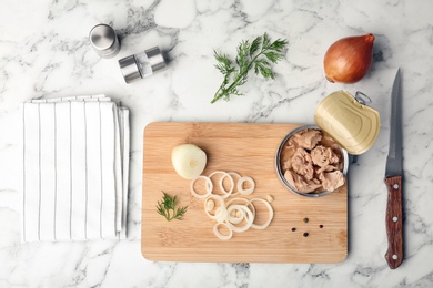 Photo of Flat lay composition with canned tuna on marble background