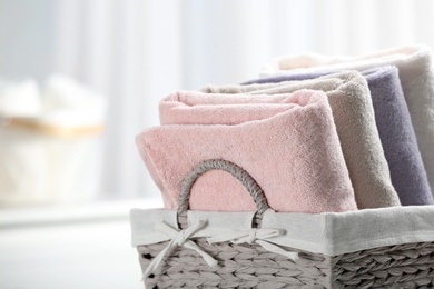 Basket of fresh towels, closeup. Space for text