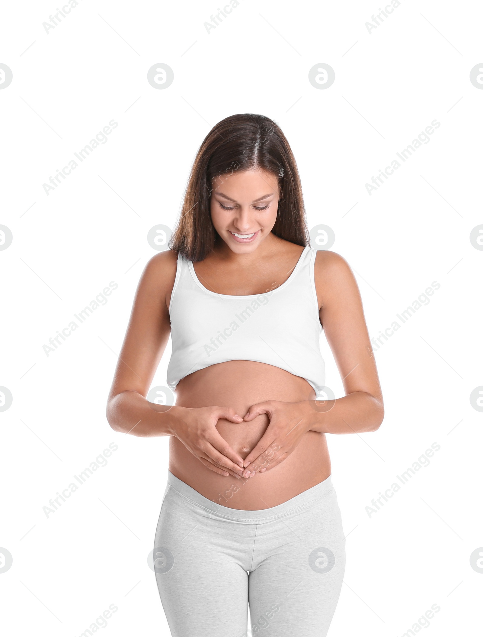 Photo of Happy pregnant woman posing on white background