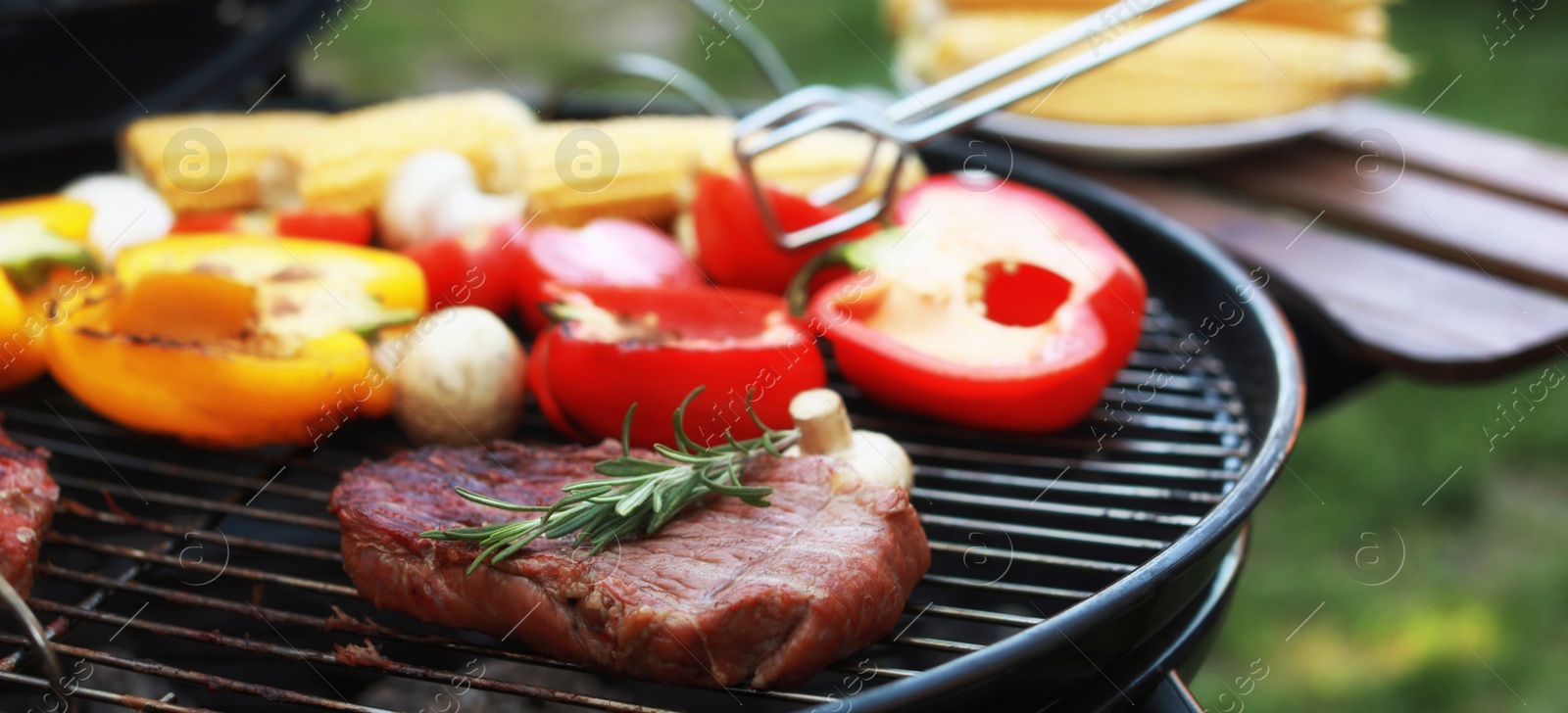 Image of Cooking meat and vegetables on barbecue grill outdoors, closeup. Banner design