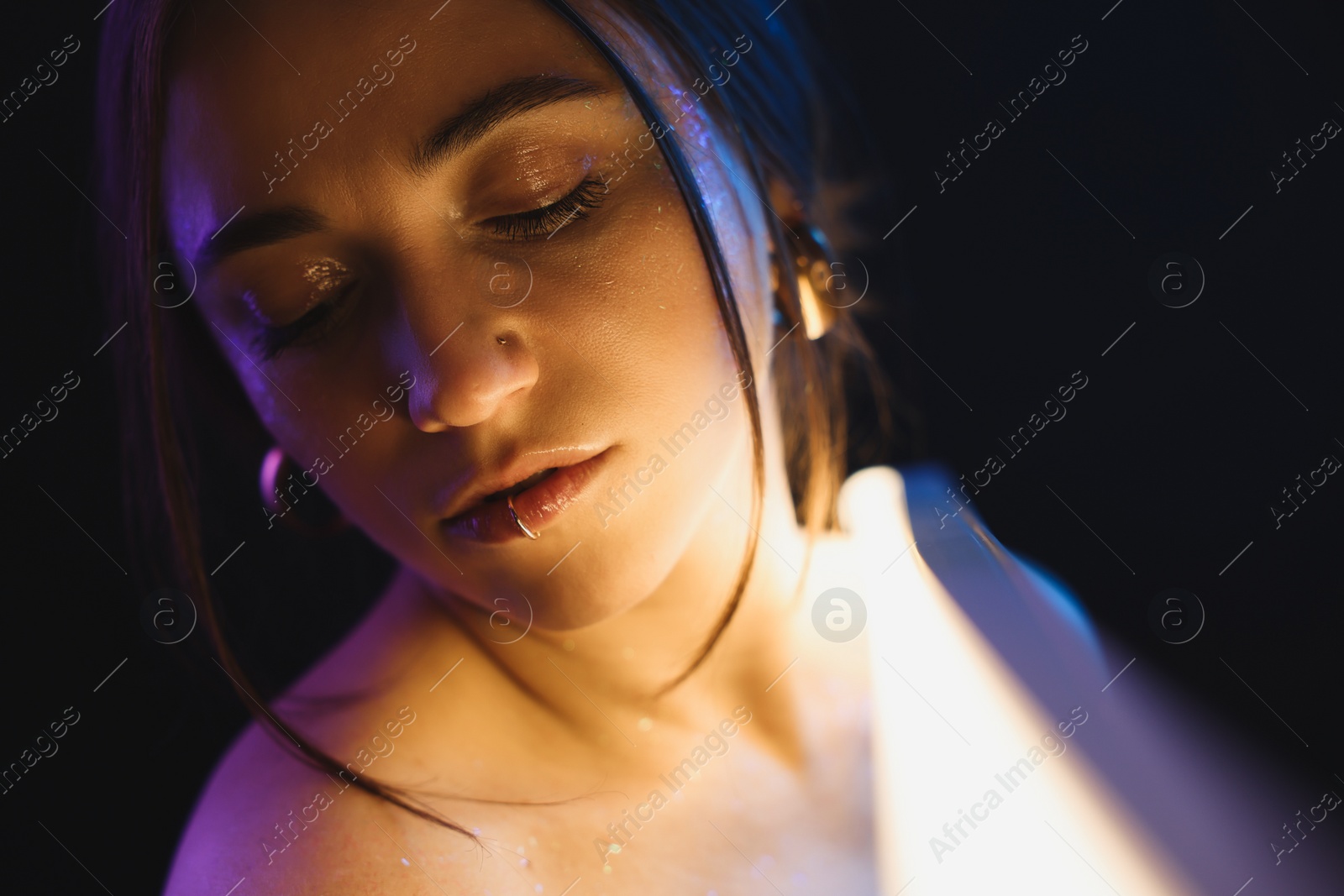 Photo of Beautiful woman on dark background in neon lights