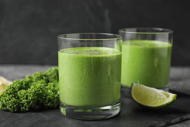 Photo of Tasty kale smoothie with chia seeds on black table, closeup