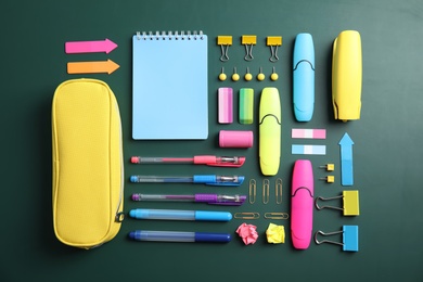 Flat lay composition with different school stationery on chalkboard surface