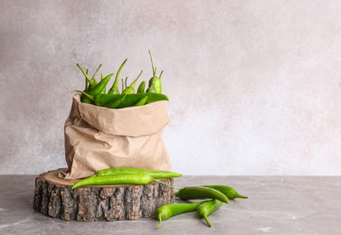 Paper bag with chili peppers on table