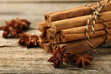 Cinnamon sticks and star anise on wooden table, closeup