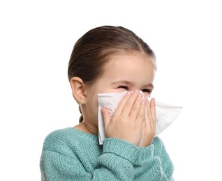 Photo of Girl blowing nose in tissue on white background. Cold symptoms