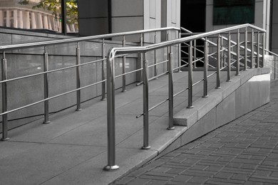 Photo of Ramp with metal handrails near building outdoors