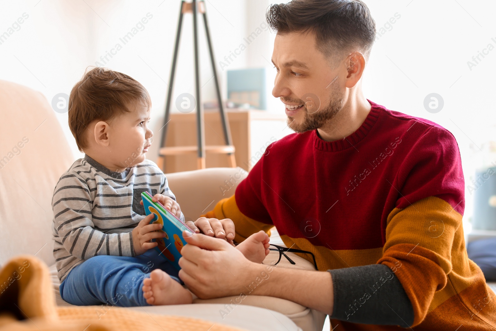 Photo of Dad spending time with his son at home