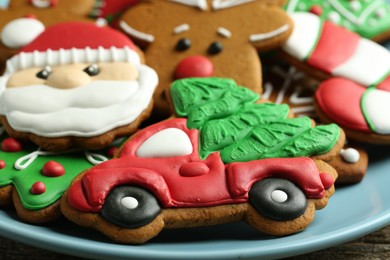 Photo of Different tasty Christmas cookies on light blue plate, closeup