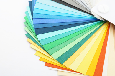 Photo of Color palette samples on white background, closeup