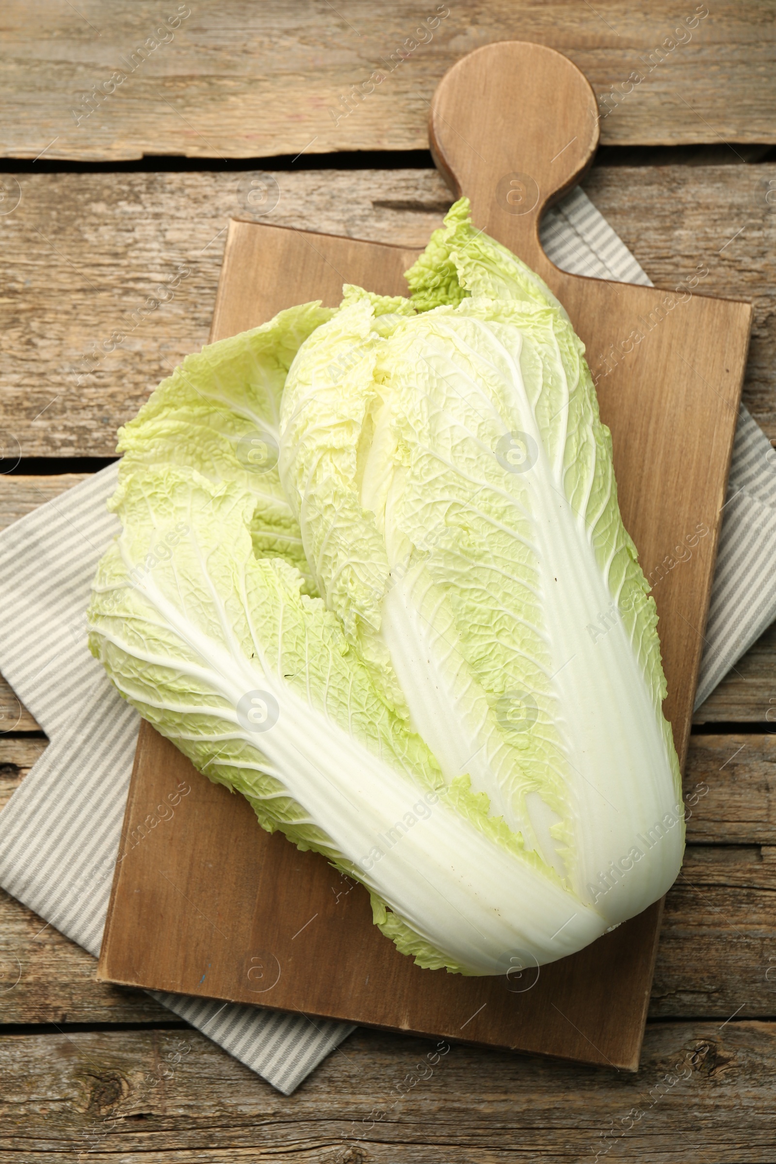 Photo of Fresh ripe Chinese cabbage on wooden table, top view