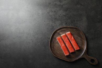 Photo of Crab sticks on grey table, top view. Space for text