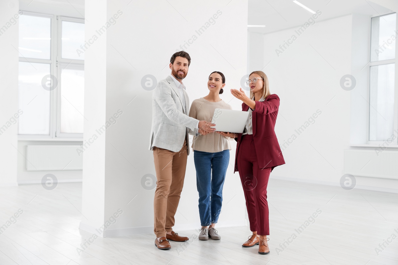 Photo of Real estate agent showing new apartment to couple