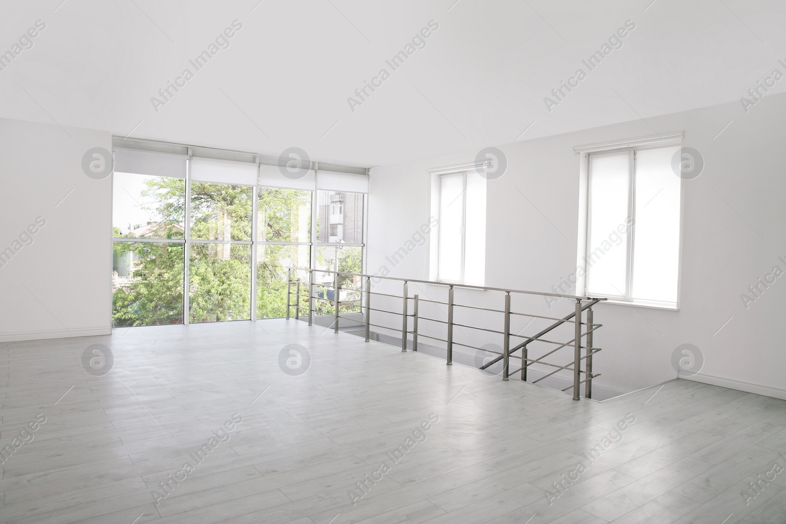 Photo of Empty room with windows and laminated floor