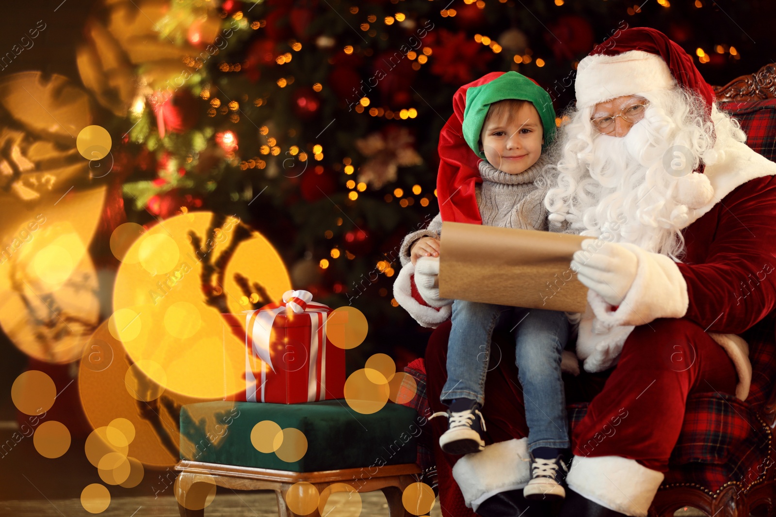 Photo of Santa Claus and little boy near Christmas tree indoors