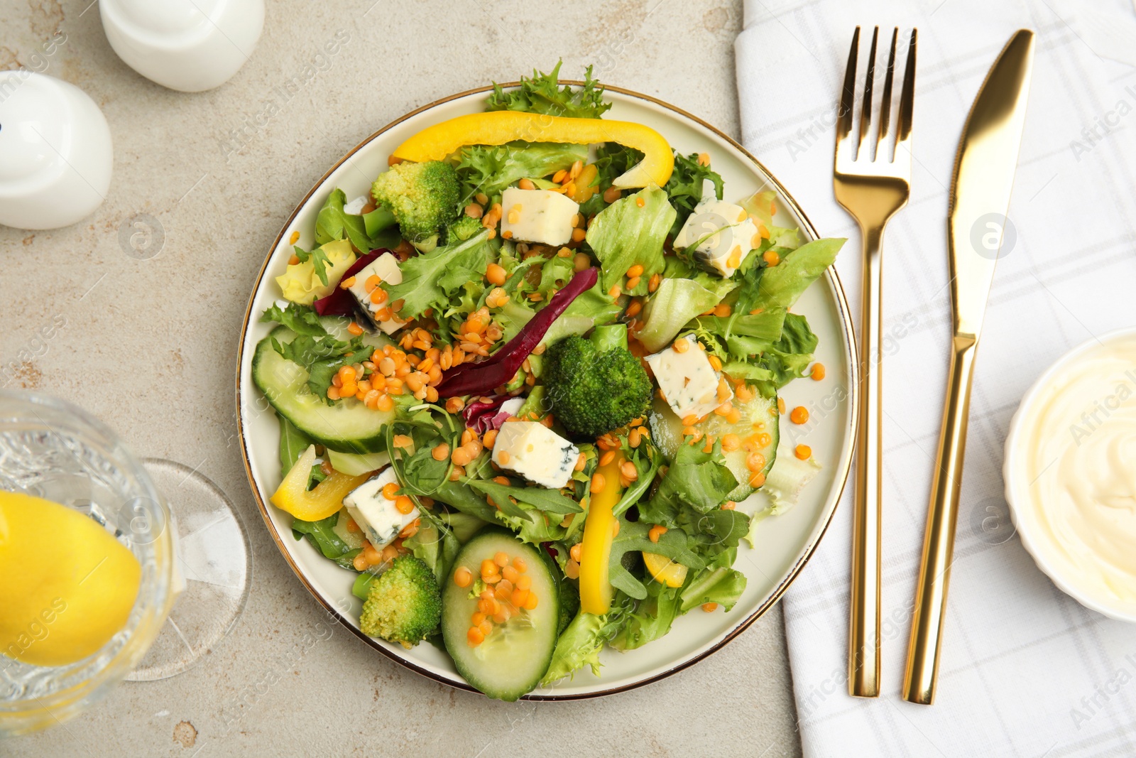 Photo of Delicious salad with lentils, vegetables and cheese served on light grey table, flat lay