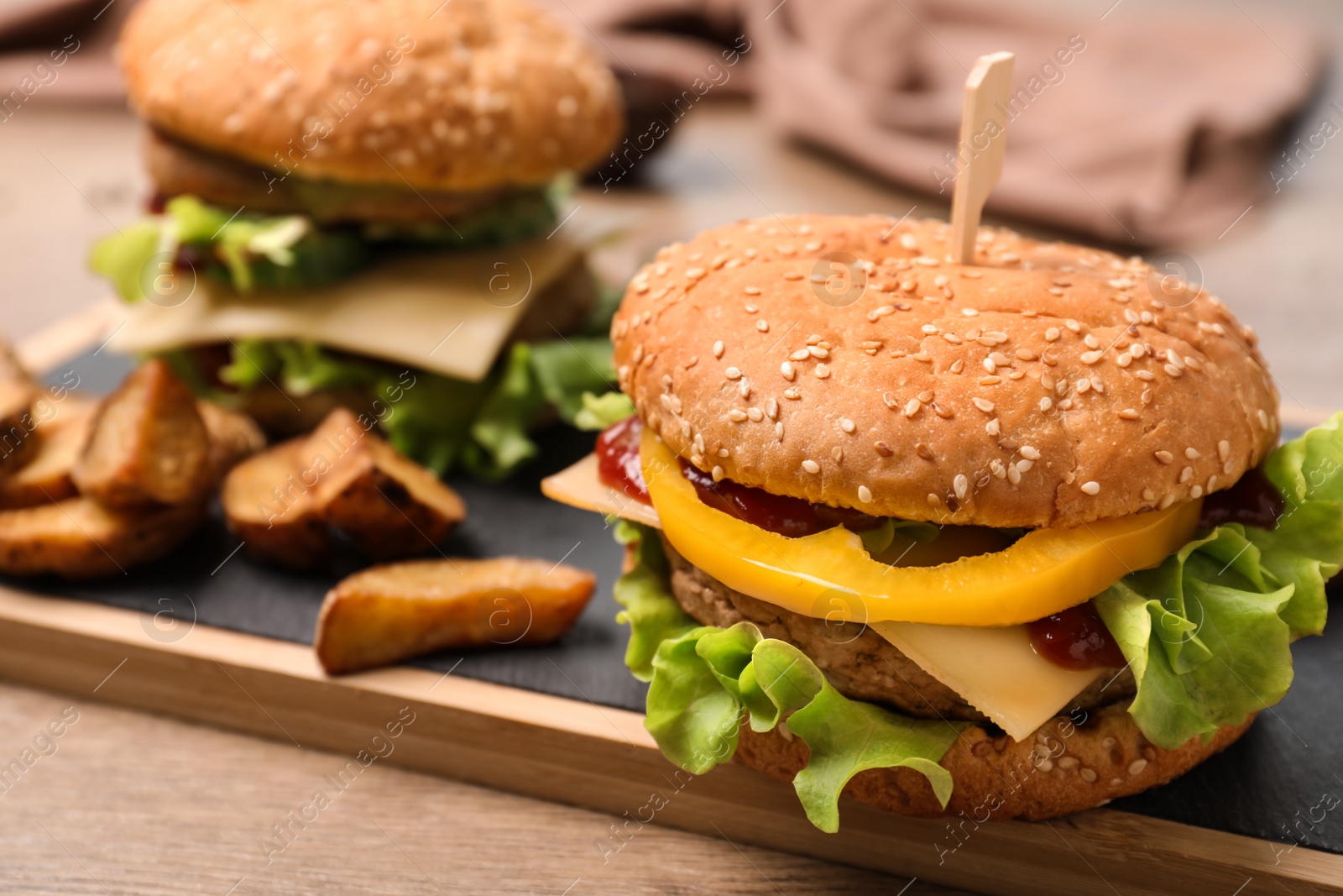 Photo of Board with delicious hamburger on table. Space for text