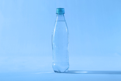Photo of Plastic bottle of pure water on color background
