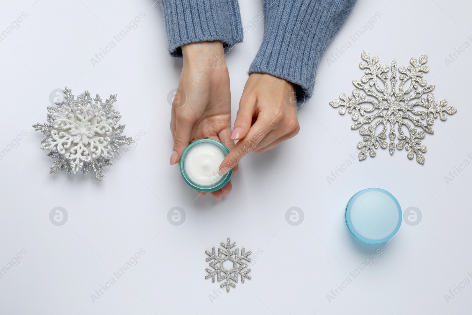 Photo of Woman with jar of hand cream on white background, top view