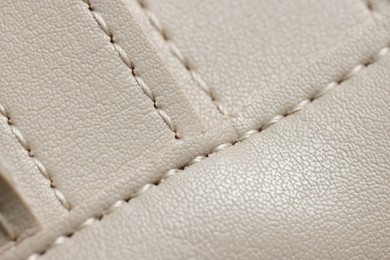 Photo of Beige leather with seams as background, closeup view
