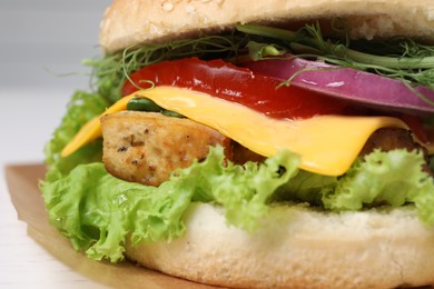 Delicious burger with tofu and fresh vegetables on table, closeup